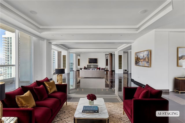 living room with a raised ceiling and light tile patterned floors