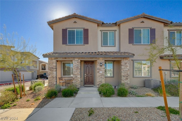 view of front of house with a garage and central AC unit