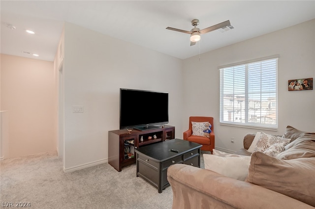 living room featuring light carpet and ceiling fan