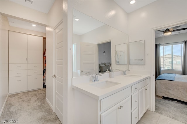 bathroom featuring tile flooring, dual sinks, ceiling fan, and large vanity