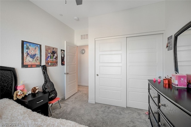 bedroom with light carpet and a closet