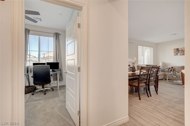 office space with light hardwood / wood-style floors and ceiling fan