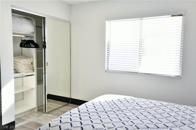 bedroom with a closet and light wood-type flooring