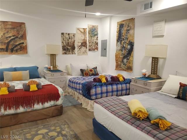 bedroom with ceiling fan and hardwood / wood-style flooring