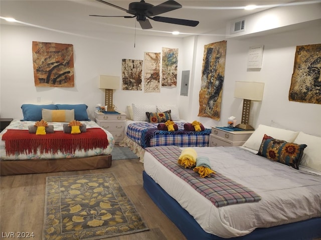 bedroom with ceiling fan and hardwood / wood-style flooring