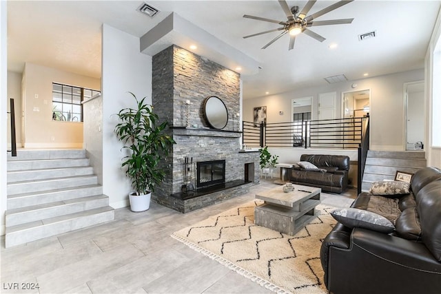 living room with a fireplace and ceiling fan