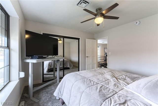 carpeted bedroom with ceiling fan and a closet