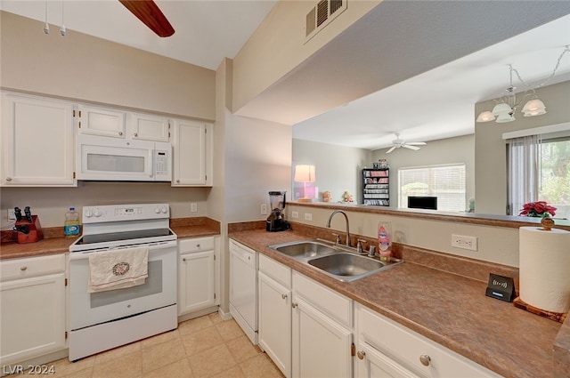 kitchen featuring white cabinetry, light tile floors, white appliances, ceiling fan with notable chandelier, and sink