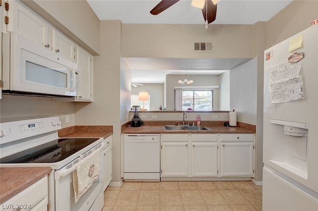 kitchen featuring white cabinetry, light tile floors, white appliances, ceiling fan with notable chandelier, and sink