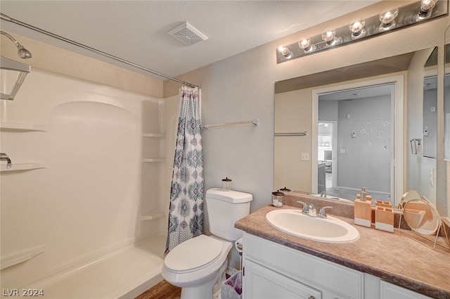 bathroom with a shower with shower curtain, large vanity, and toilet