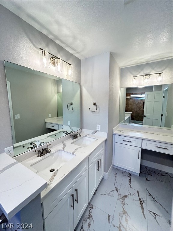 bathroom with double sink, tile floors, a textured ceiling, and large vanity