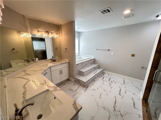 bathroom featuring tile flooring, dual sinks, oversized vanity, and a relaxing tiled bath