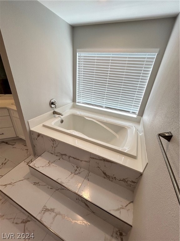 bathroom with tile floors and tiled bath