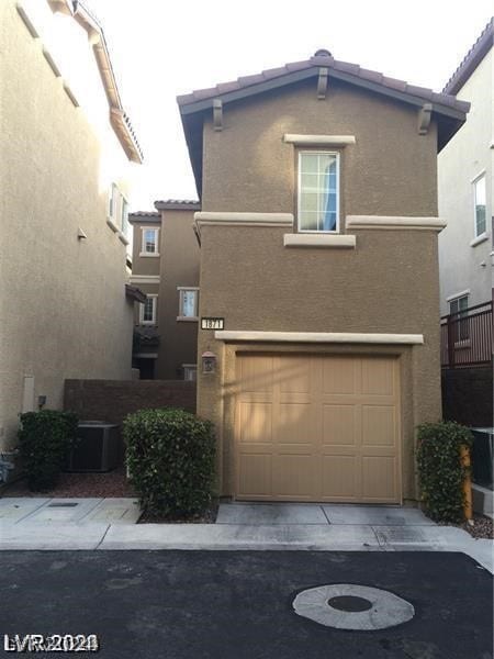 view of property with central AC and a garage