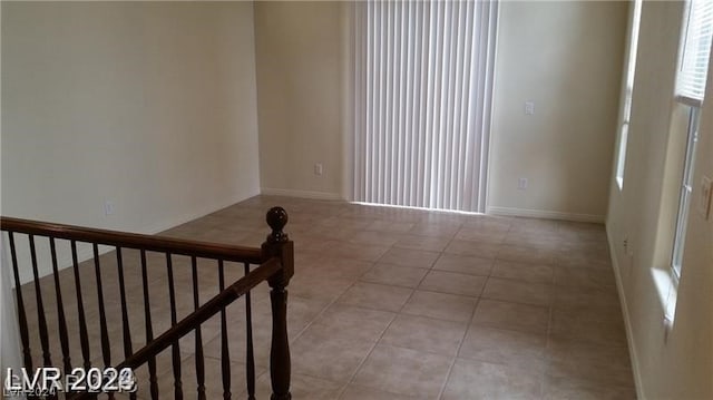 unfurnished room featuring light tile flooring