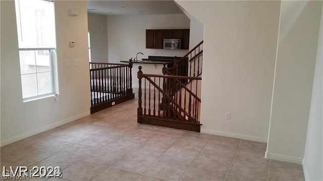 interior space featuring light tile floors and sink