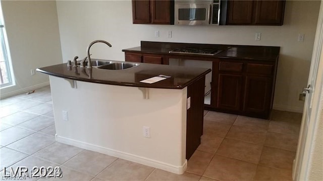 kitchen with sink, black electric stovetop, and light tile flooring