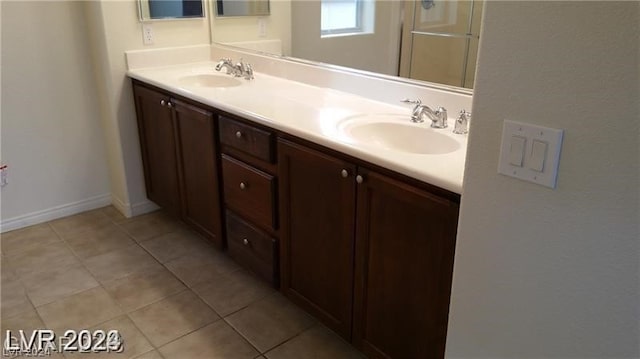 bathroom featuring tile floors and dual bowl vanity