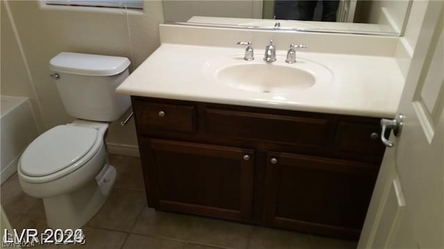 bathroom with tile floors, toilet, and vanity