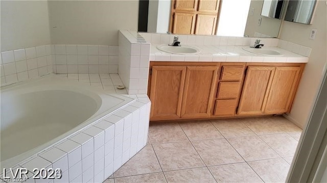 bathroom with tiled bath, dual vanity, and tile floors