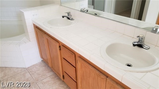 bathroom with tile flooring, double vanity, and a bathtub