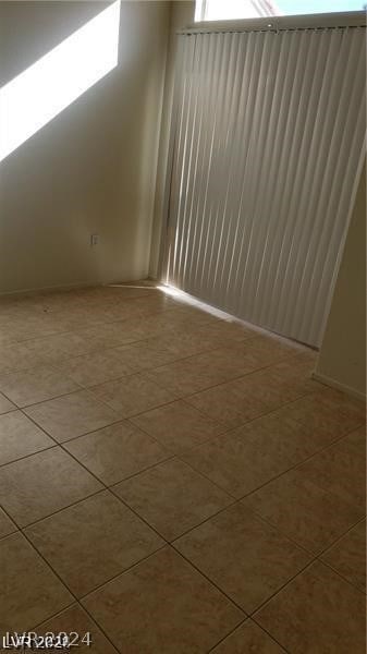 unfurnished room with light tile floors