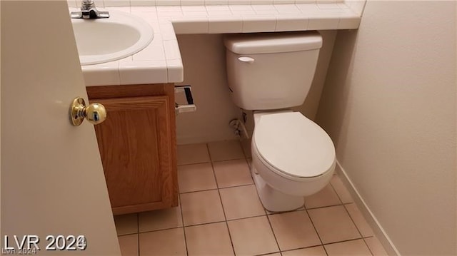 bathroom featuring tile floors, toilet, and vanity