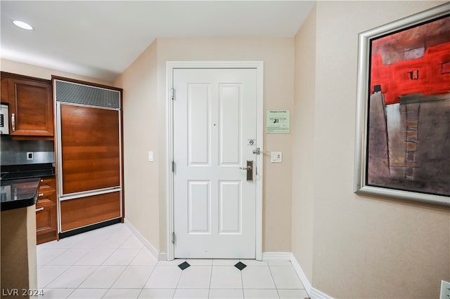 kitchen featuring light tile flooring and paneled built in fridge