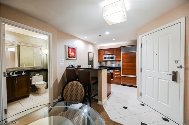 kitchen with light tile floors and paneled built in refrigerator