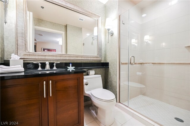 bathroom featuring tile flooring, toilet, vanity, and walk in shower