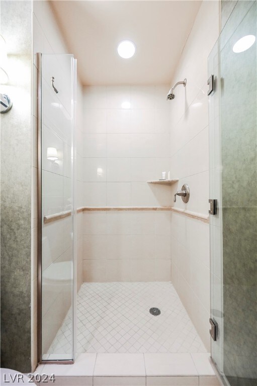 bathroom with a shower with door