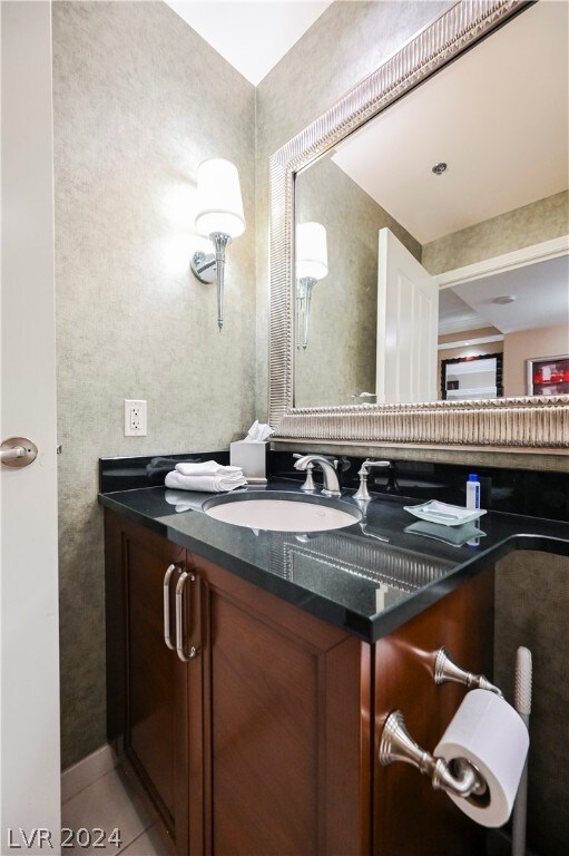 bathroom with tile flooring and vanity