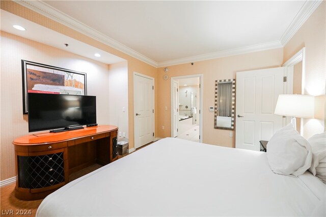 bedroom featuring ornamental molding and ensuite bathroom