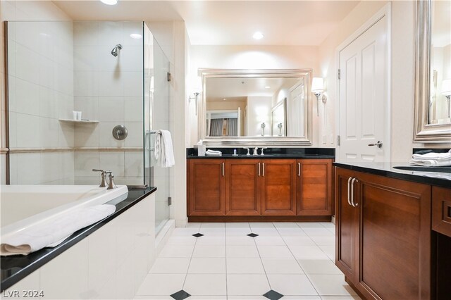 bathroom featuring vanity, tile floors, and a relaxing tiled bath