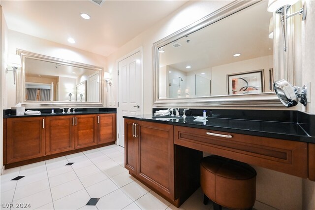 interior space with sink, light tile flooring, and dark stone countertops