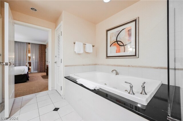 bathroom featuring tile flooring and a bath to relax in