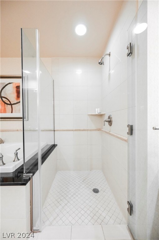 bathroom featuring shower with separate bathtub