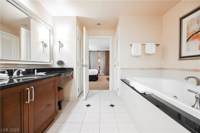 bathroom featuring a bathing tub, tile flooring, and large vanity