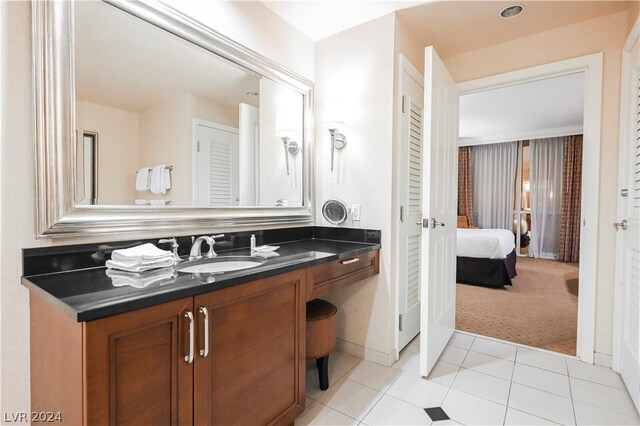 bathroom featuring tile floors and vanity