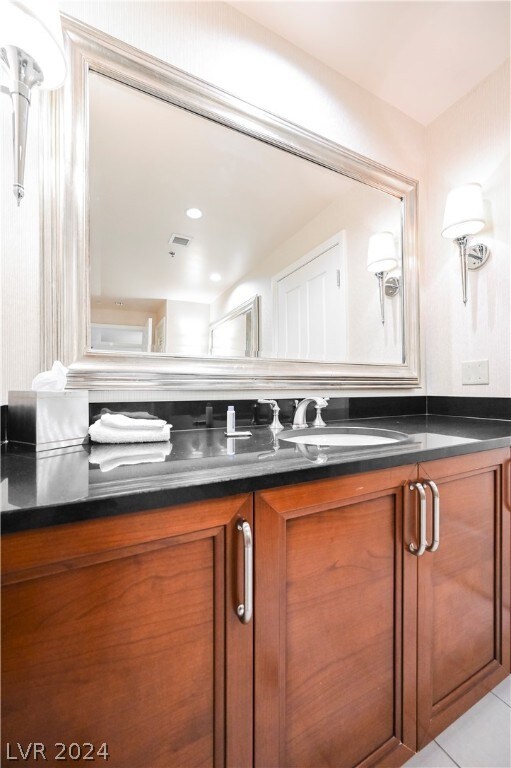 bathroom with tile floors and vanity