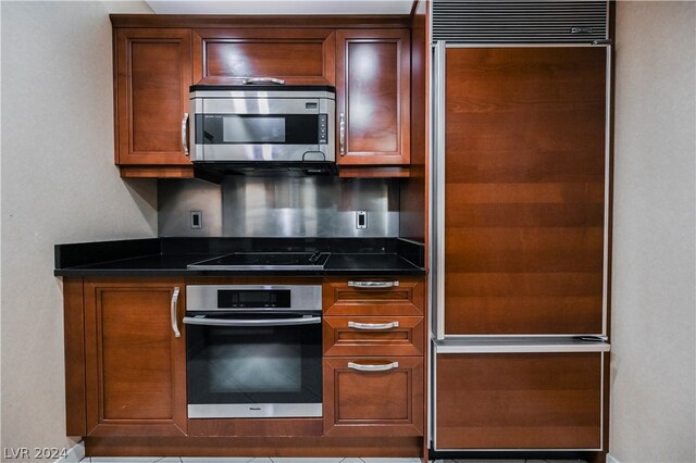 kitchen featuring appliances with stainless steel finishes and dark stone countertops