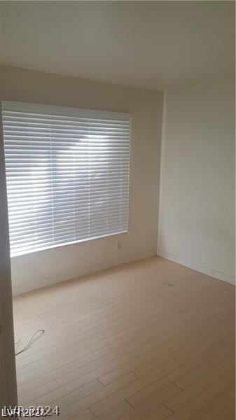 spare room with light wood-type flooring