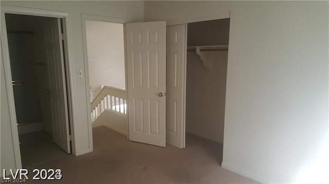 unfurnished bedroom with dark carpet and a closet