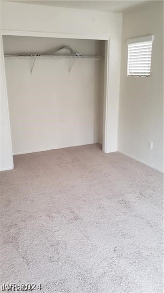 unfurnished bedroom with a closet and carpet floors