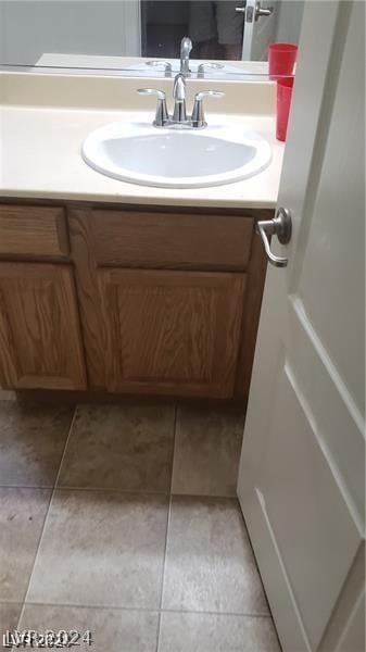 bathroom with tile flooring and vanity