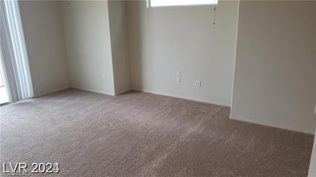 unfurnished room with light colored carpet