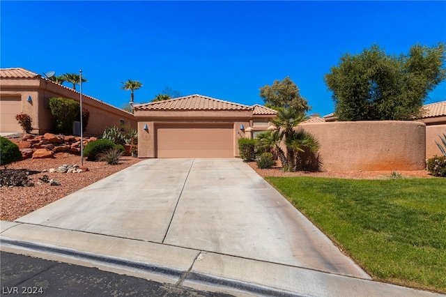 view of front of house with a garage and a front yard