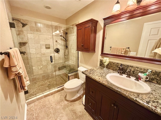 bathroom with toilet, vanity, an enclosed shower, and tile floors