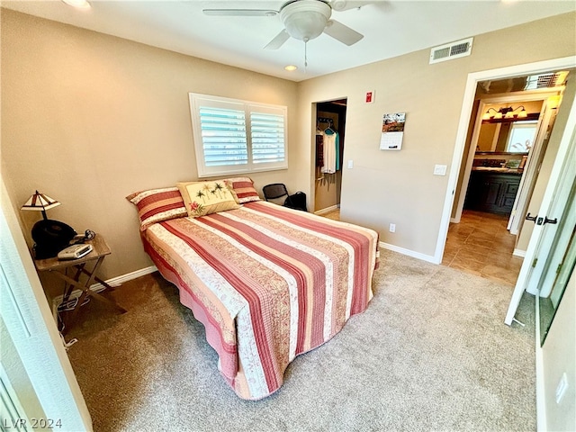 bedroom with ceiling fan and light carpet