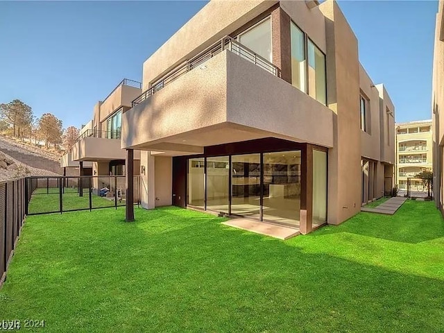 rear view of house featuring a lawn